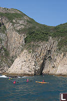 Kayakers Entering Sea Arch