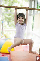 Claira Swinging On Bar