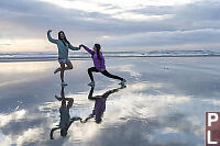 Kids Dancing On Wet Sand